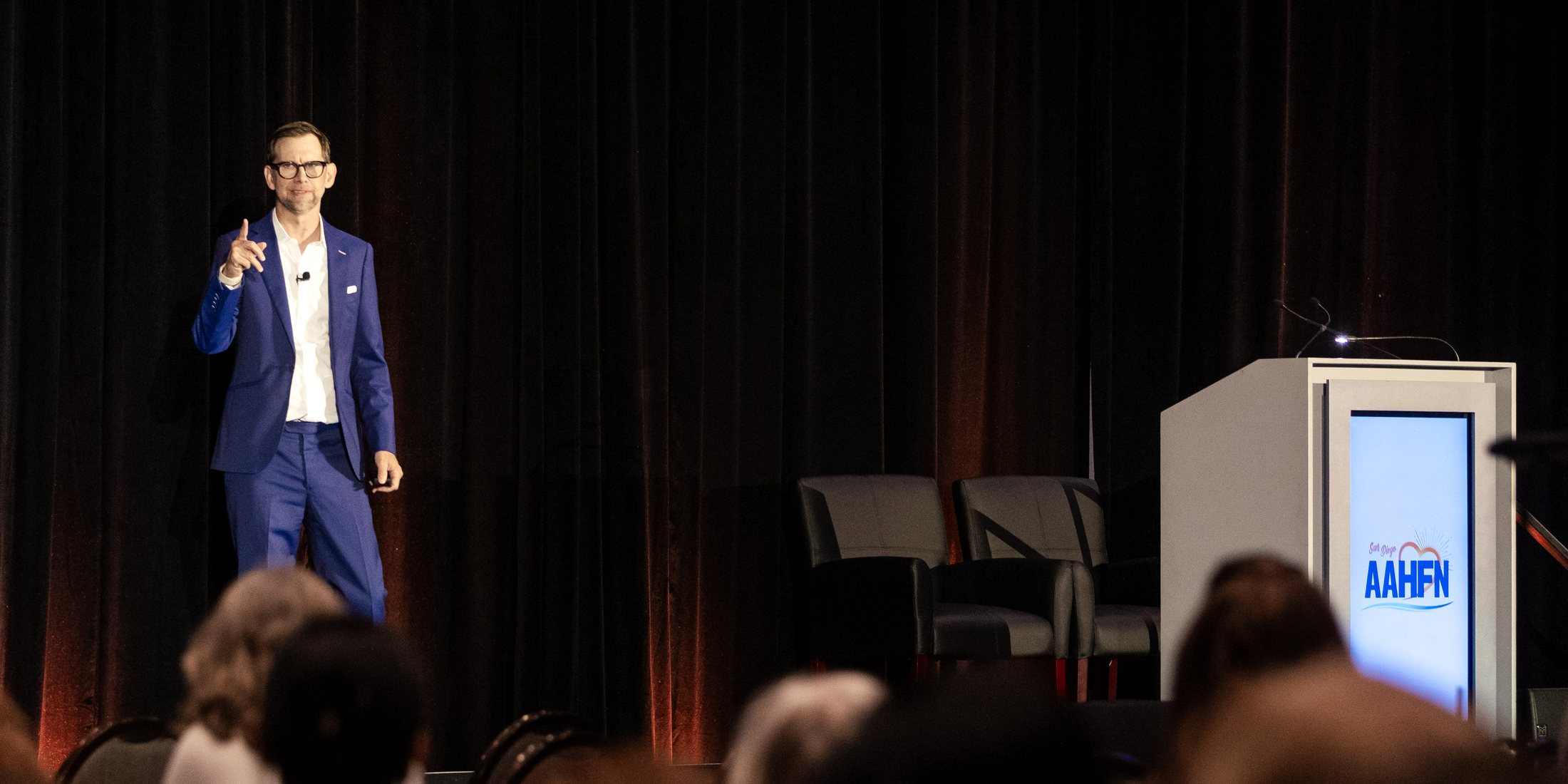 Michael Kutcher on stage in front of a full conference audience