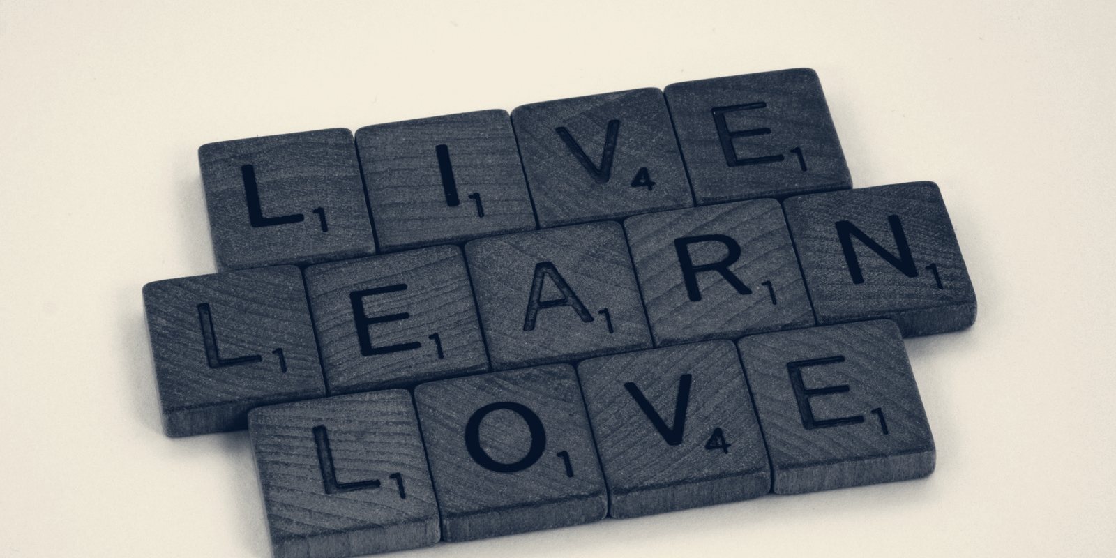 Letter tiles spelling the words Live, Learn, Love
