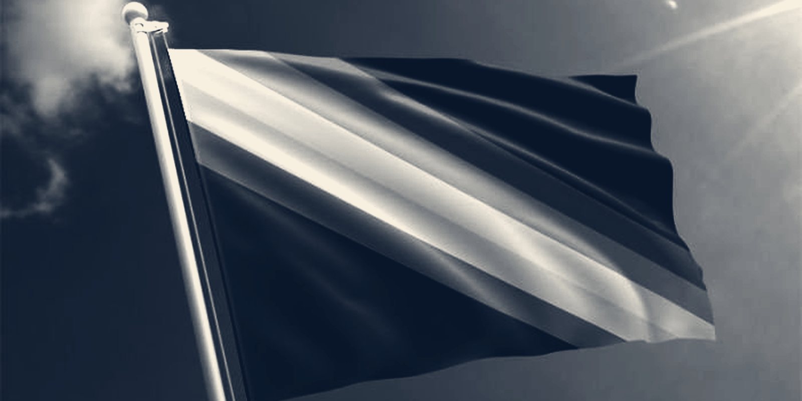 A flag with a band of diagonal stripes flying from a flagpole